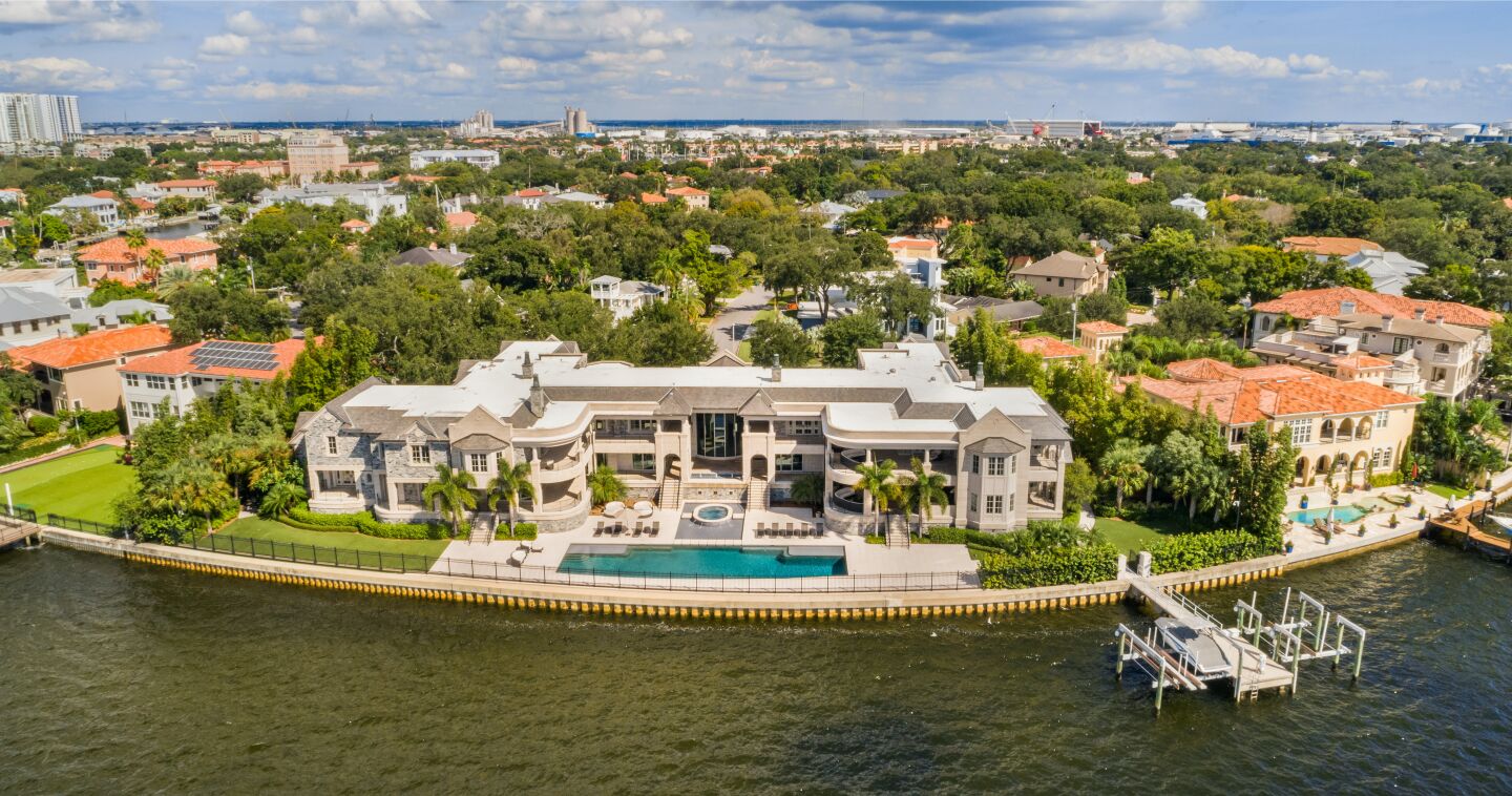 Aerial view of the mansion, pool and dock.
