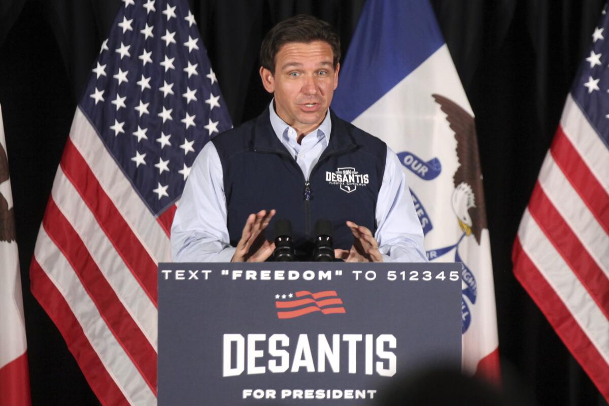 Ron DeSantis at a lectern with American flags behind him