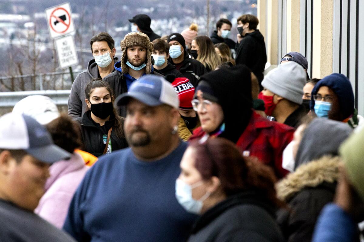 People waiti in line for a GameStop store in Dickson City, Pa., to open on Friday