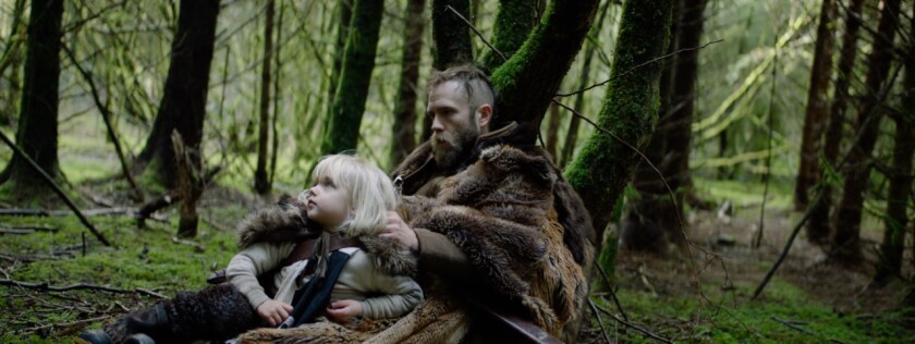 Bodhi Palmer and his Mark Webber are surrounded by mossy trees in a forest.