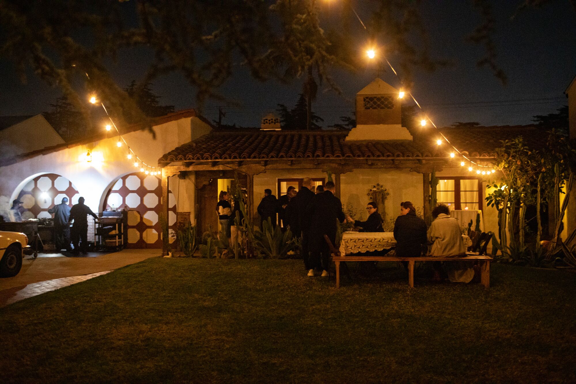 A yard and house with string lights