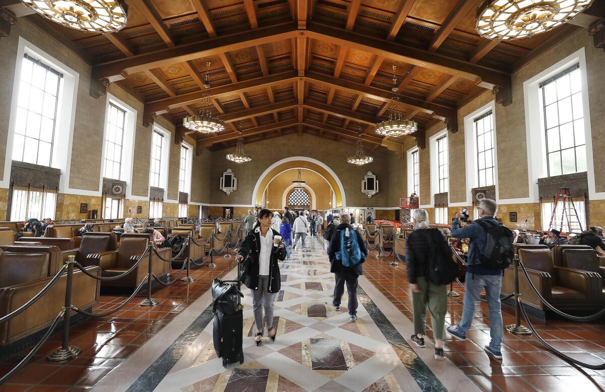 Passengers file through the main lobby of Los Angeles Union Station, celebrating its 80th anniversary. (Al / Los Angeles Times)