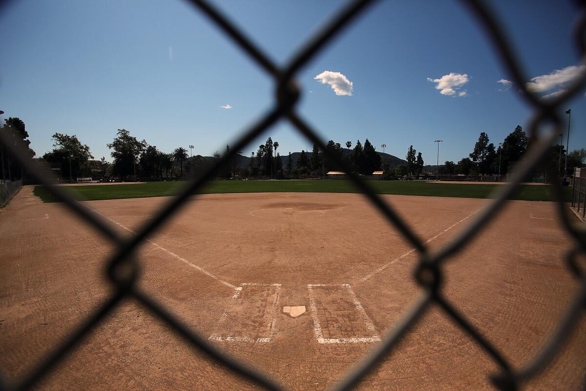 The softball field at Olive Park is vacant after the high school season was canceled because of the coronavirus.