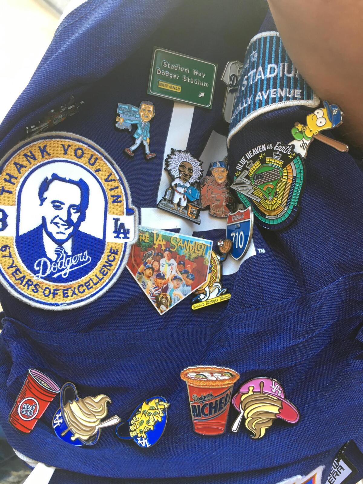 Richard Lomeli and some of the pins he designed.