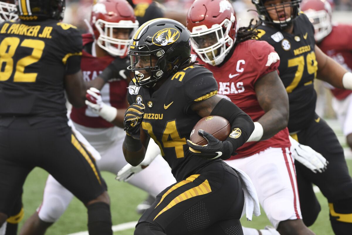 FILE - In this Nov. 29, 2019, file photo, Missouri running back Larry Rountree III finds a hole in the Arkansas defense as he runs the ball during the first half of an NCAA college football game in Little Rock, Ark. Eli Drinkwitz already has experienced just about everything a college football coach could imagine in his first season. Except for playing a game. That will finally change on Sept. 26, 2020, when the Tigers’ new coach leads his team into the opener of its SEC-only schedule against mighty Alabama. (AP Photo/Michael Woods, File)