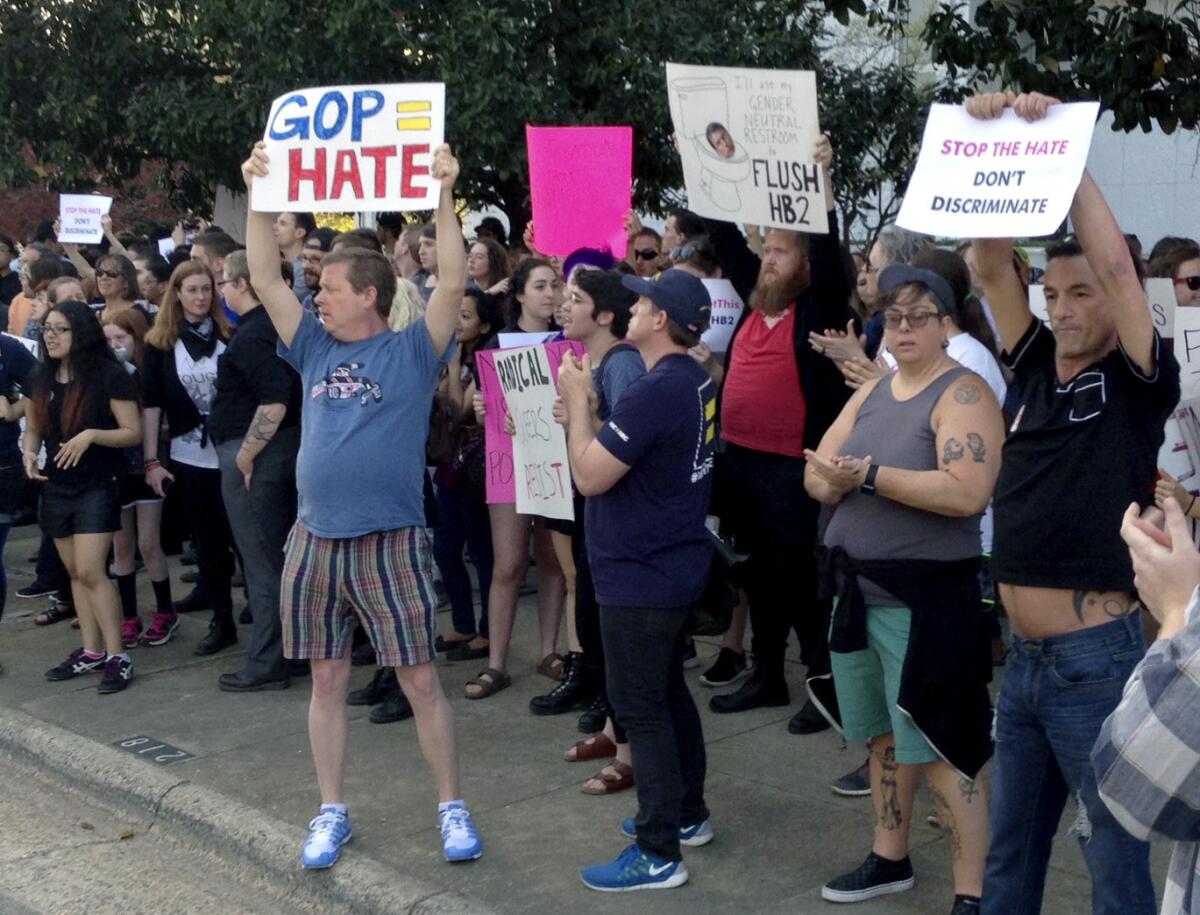 After a law was passed that prevents cities and counties from passing their own anti-discrimination rules, people protest outside the North Carolina Executive Mansion in Raleigh on Thursday.