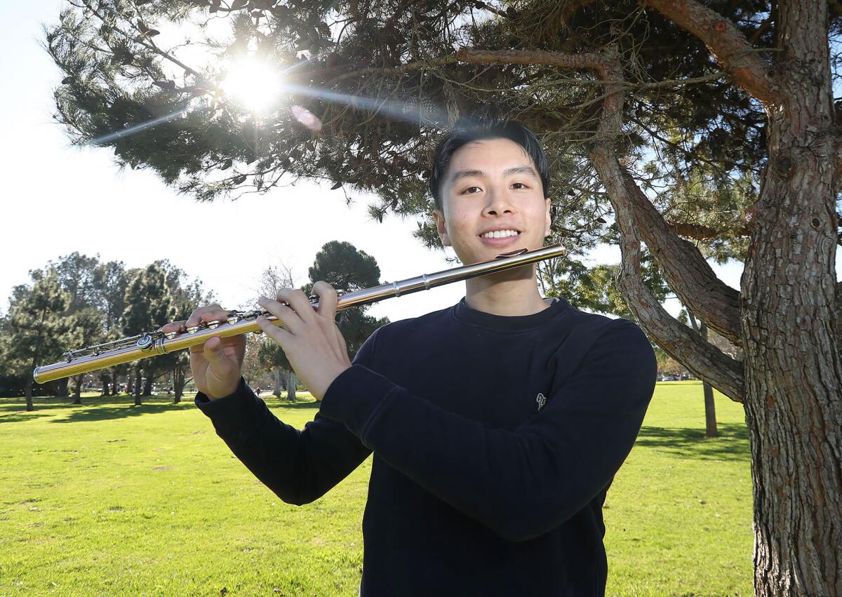 Flute player Khoi Dinh poses for a portrait at Central Park in Huntington Beach.