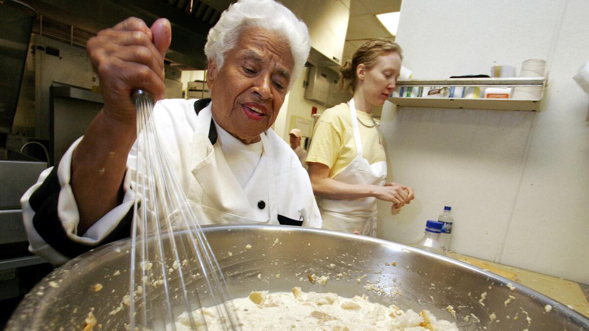Leah Chase mixes her bread pudding at Muriel's restaurant in New Orleans on April 12, 2006.