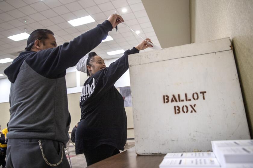 Buena Park, CA, Monday, April 11, 2022 - Albertson's employees Marissa Pena and Stephen Sanchez deliver their votes to a ballot box on a union contract at UFCW Local 324. (Robert Gauthier/Los Angeles Times)