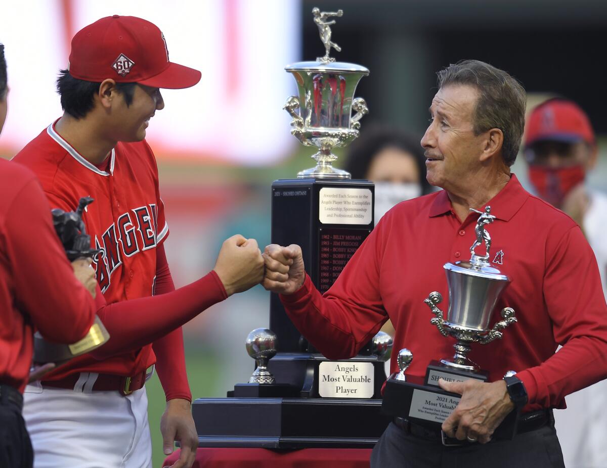 The Angels' Shohei Ohtani gets a fist bump from Arte Moreno before being given the Angels Most Valuable player award.