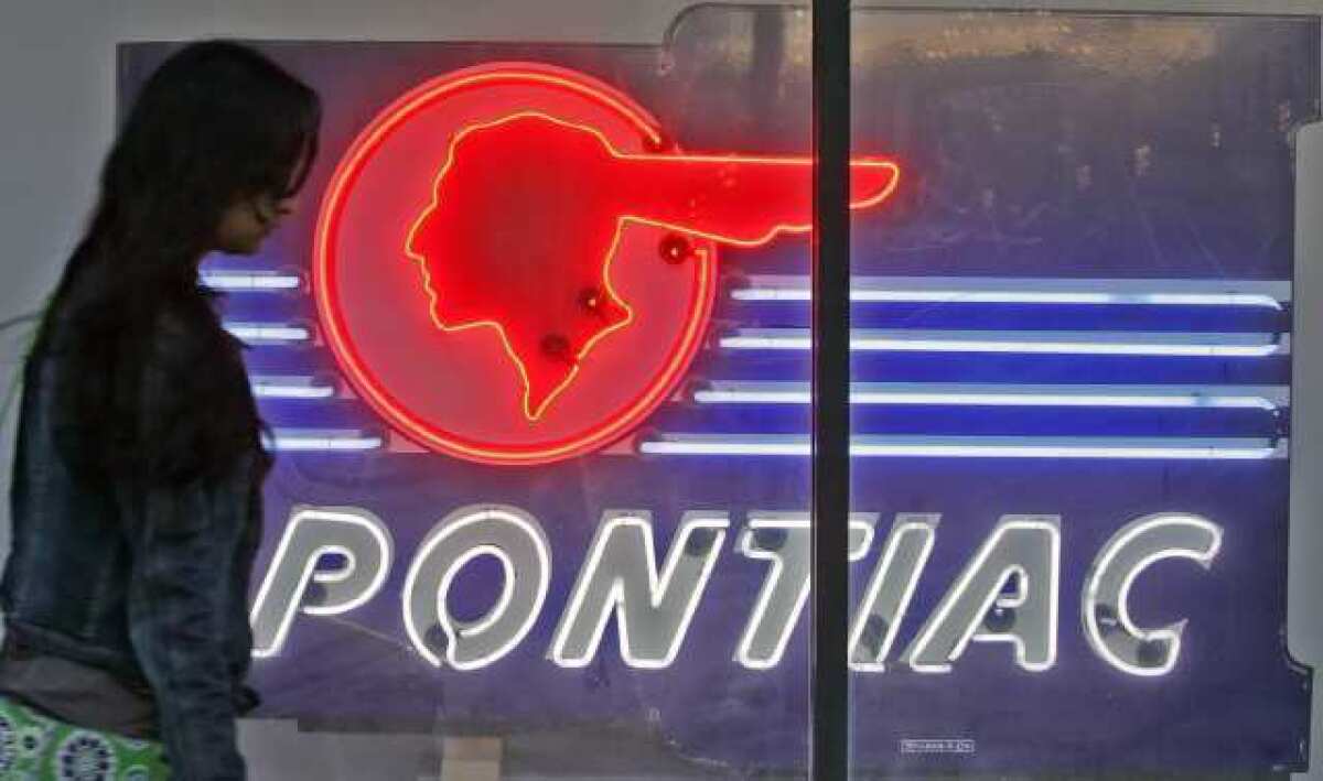 A pedestrian walks by a neon display at 216 S. Brand Blvd., the future location of the Museum of Neon Art.