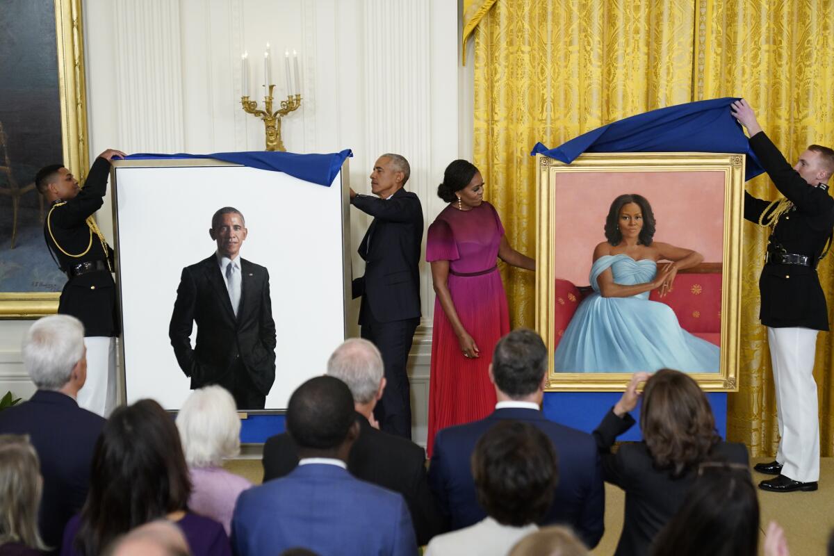 Veils over the Obamas' official portraits are formally thrown back.