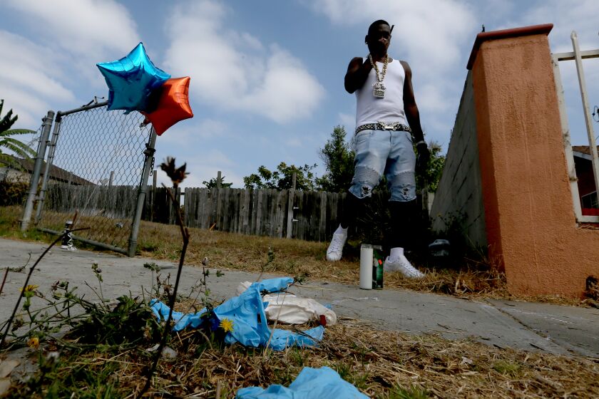 LOS ANGELES, CA - SEP. 1, 2020. Communiy activist Reggie Cole pays a visit Tuesday, Sept. 1, 2020, to the site near the intersection of W. 109th Place and S. Budlong Avenue, where Dijon Kizzee , 29, man was shot and killed by L.A. County Sheriff's deputies. The shootting of Kizzee on Monday afternoon, Aug. 31, 2020, resulted in a standoff between protesters and police that continued into the night. (Luis Sinco / Los Angeles Times)