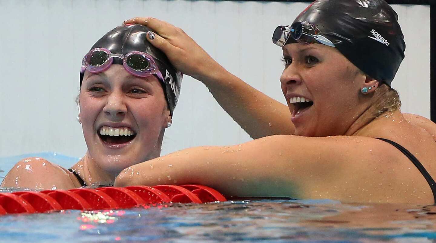 Missy Franklin, left, and U.S. swimming teammate Elizabeth Beisel celebrate at the finish line of the women's 200m backstroke. Franklin won the gold medal and set a new world record time of 2:04:06. Beisel finished third for the bronze medal.