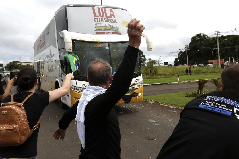 Opponents of Brazil's former President Luiz Inacio Lula da Silva throw eggs at his caravan arriving to Sao Miguel do Oeste in southern Brazil, Sunday, March 25, 2018. The former leader is leading polls for Octoberâs presidential election but is likely to be barred from running and judges could order him early as Monday to begin serving his sentence on a corruption conviction. (AP Photo/Eraldo Peres)