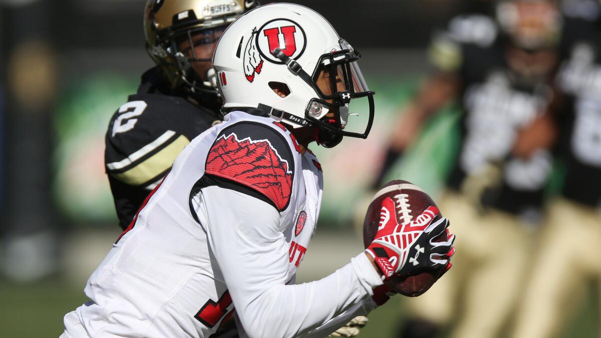 Utah wide receiver Delshawn McClellon, front, catches a pass in front of Colorado defensive back Ken Crawley during the second quarter of the Utes' 38-34 victory Saturday.