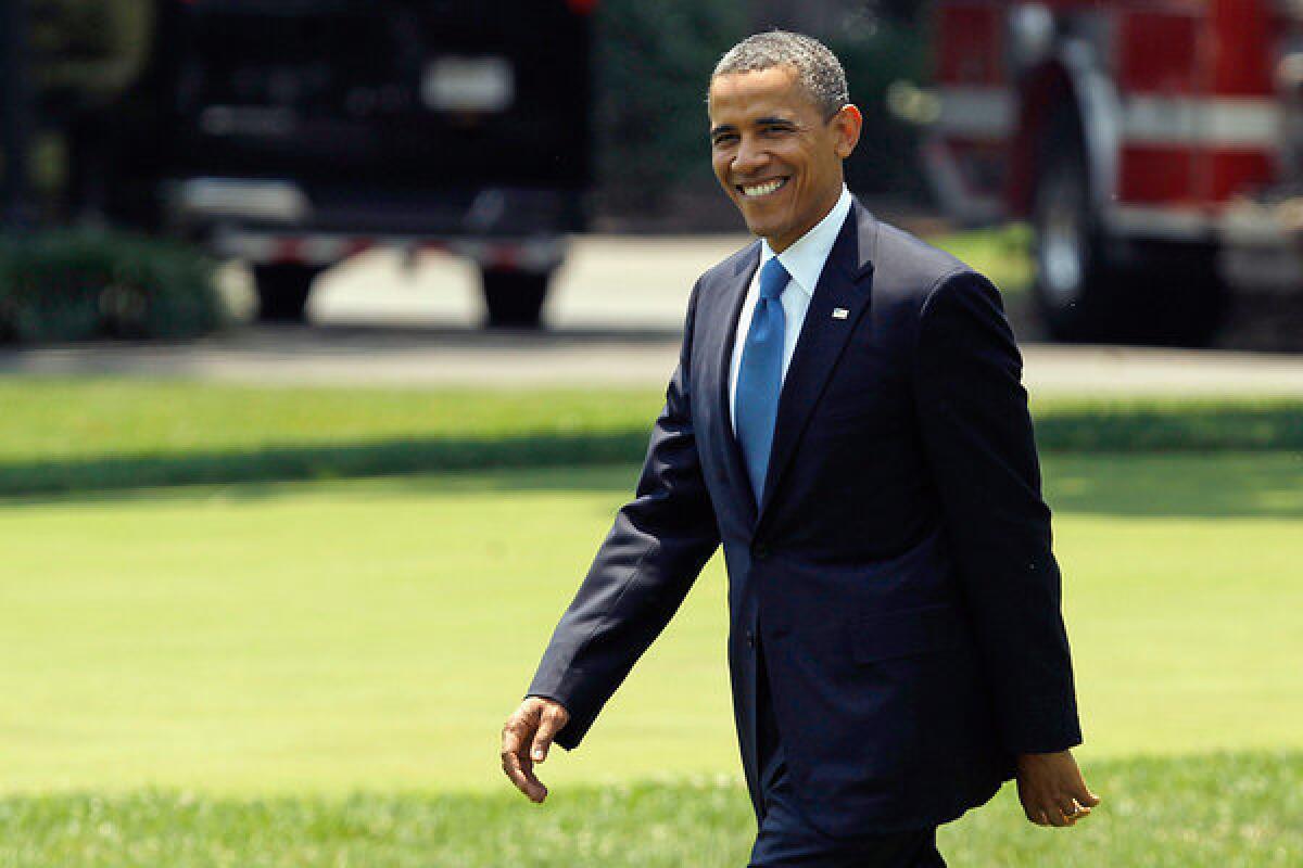 President Obama walks across the South Lawn after learning the Supreme Court's decision on his healthcare package.
