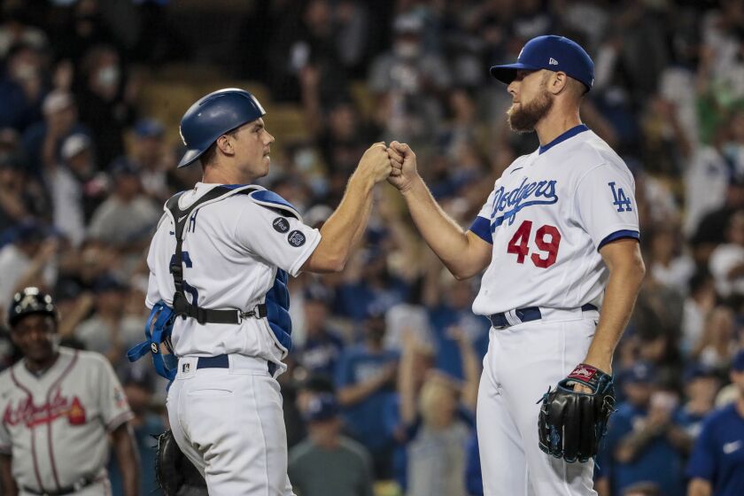 Los Angeles, CA, Monday, August 30, 2021 - Los Angeles Dodgers relief pitcher Blake Treinen (49) and Los Angeles Dodgers catcher Will Smith (16) celebrate after completing a 5-3 win over the Atlanta Braves at Dodger Stadium. (Robert Gauthier/Los Angeles Times)