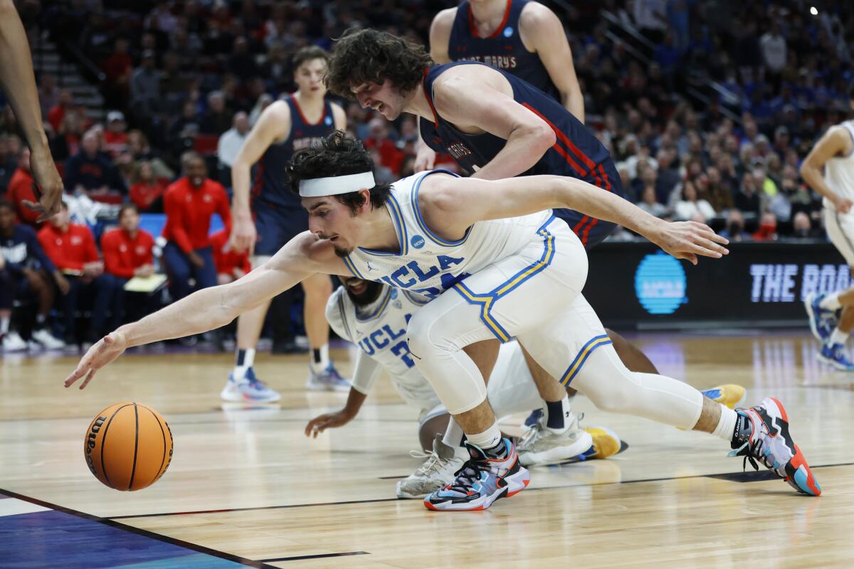 UCLA guard Jaime Jaquez Jr. reaches to try and keep the ball in-bounds an NCAA tournament game