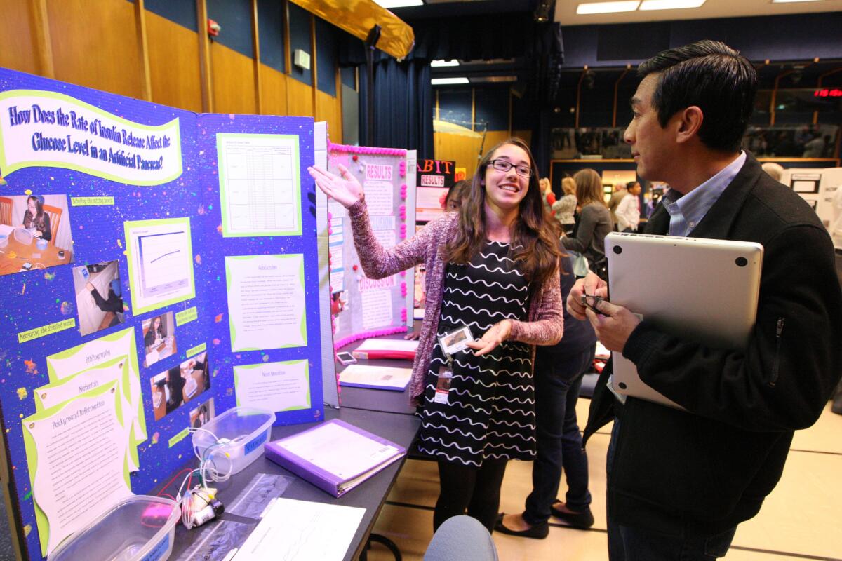 John Muir Middle School student Sarah Garelick, 13, talks about her science project with JPL software engineer Vincent Hung during the L.A. County Science Fair at NASA's Jet Propulsion Laboratory on Tuesday, April 14, 2015.