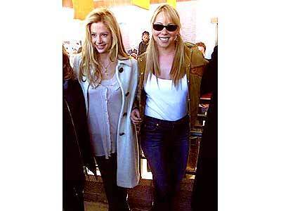 "Wise Girls" Mira Sorvino, left, and Mariah Carey dress the part as they arrive for a preview of their movie.