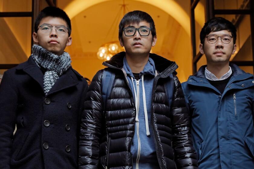 Pro-democracy activists, from left, Joshua Wong, Alex Chow and Nathan Law, walk out from the Court of Final Appeal in Hong Kong, Tuesday, Feb. 6, 2018. Hong Kong's highest court on Tuesday overturned prison sentences for three young pro-democracy activists convicted for their roles in kicking off 2014's "Umbrella Movement" protests in the semiautonomous Chinese city. (AP Photo/Vincent Yu)