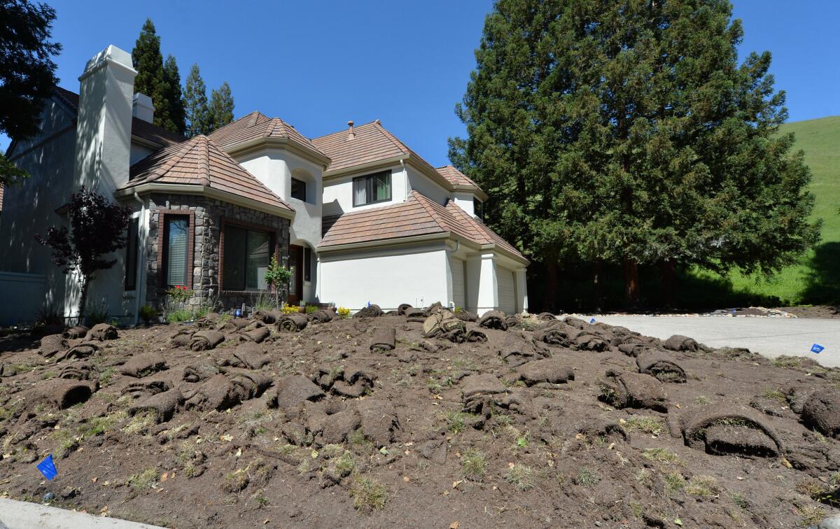 A lawn is removed for landscaping work at a home in Blackhawk, Calif.