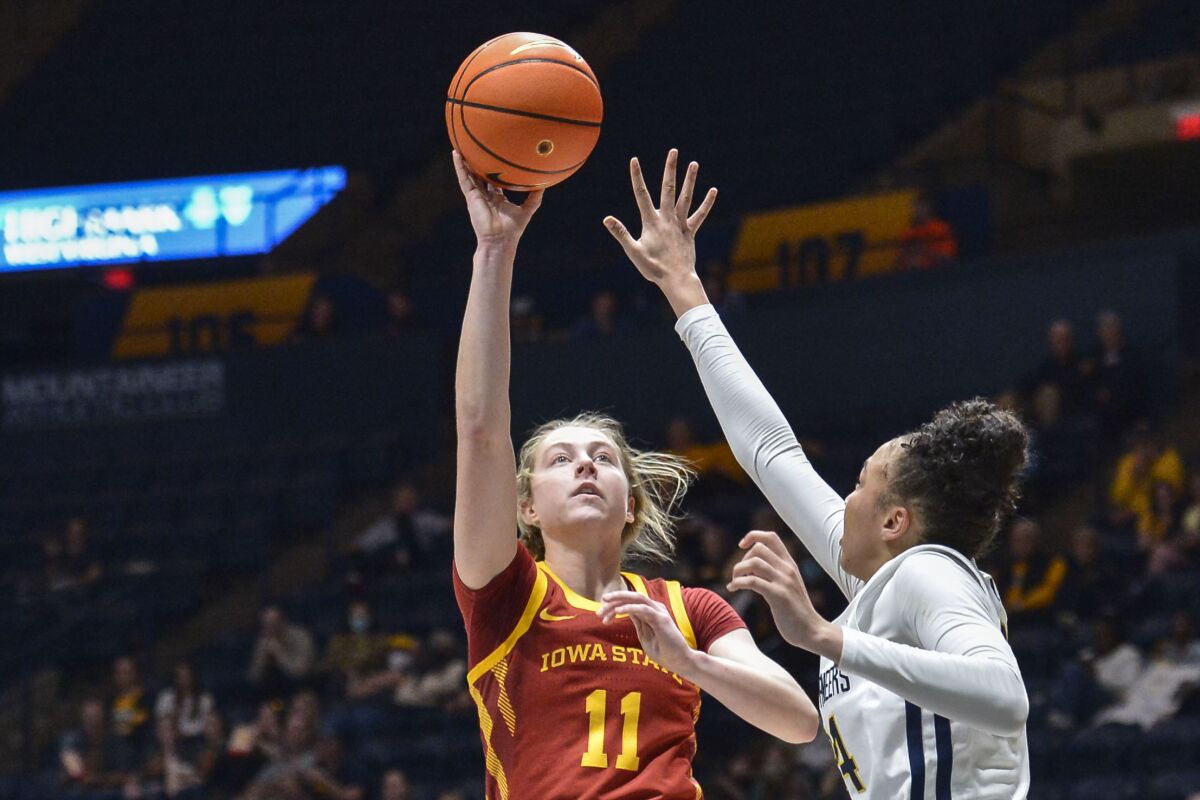 Iowa State guard Emily Ryan (11) shoots while being guarded by West Virginia guard Savannah Samuel (24) during the second half of an NCAA college basketball game in Morgantown, W.Va., Saturday, March 5, 2022. (AP Photo/William Wotring)