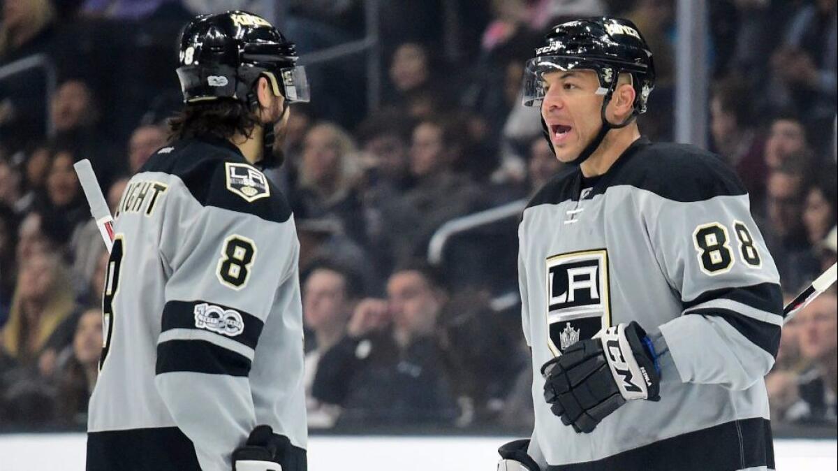 Kings center Jarome Iginla talks with defenseman Drew Doughty before a first-period faceoff against the Canucks on March 4.