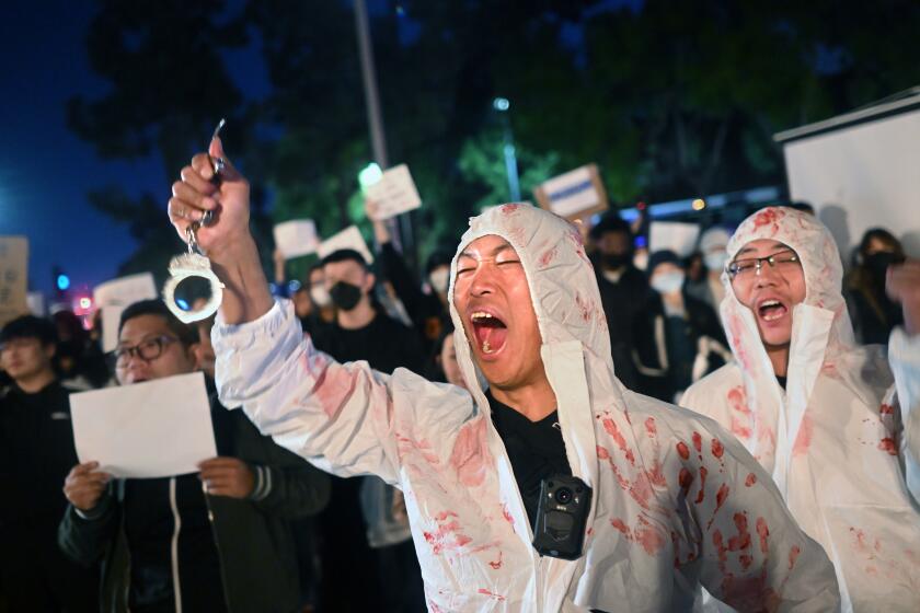 Los Angeles, California November 29, 2022-Lijian Jie yells in protest during a candlelight vigil for victims who suffer under China’s stringent lockdown in Urumqi and COVID victims on the campus of USC Tuesday night. (Wally Skalij/Los Angeles Times)