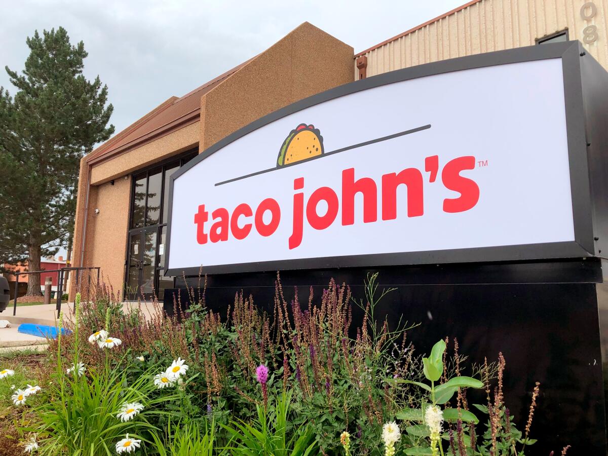 A sign stands outside the corporate headquarters of Taco John's in Cheyenne, Wyo.