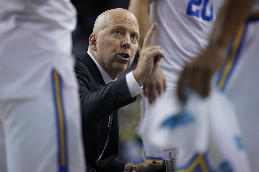 UCLA head coach Mick Cronin talks with players during a timeout in the second half of an NCAA college basketball game against the Long Beach State in Los Angeles, Monday, Nov. 15, 2021. (AP Photo/Ashley Landis)