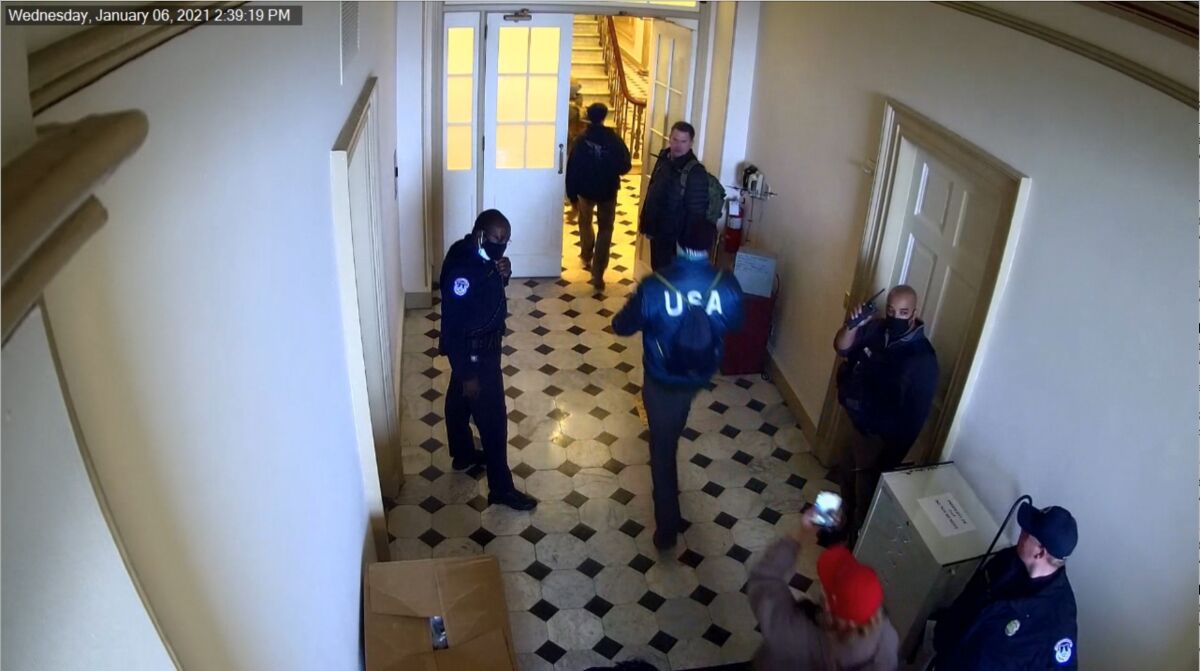 Image from security video of Klete Keller, wearing a "USA" jacket, walking down a hallway at the U.S. Capitol on Jan. 6