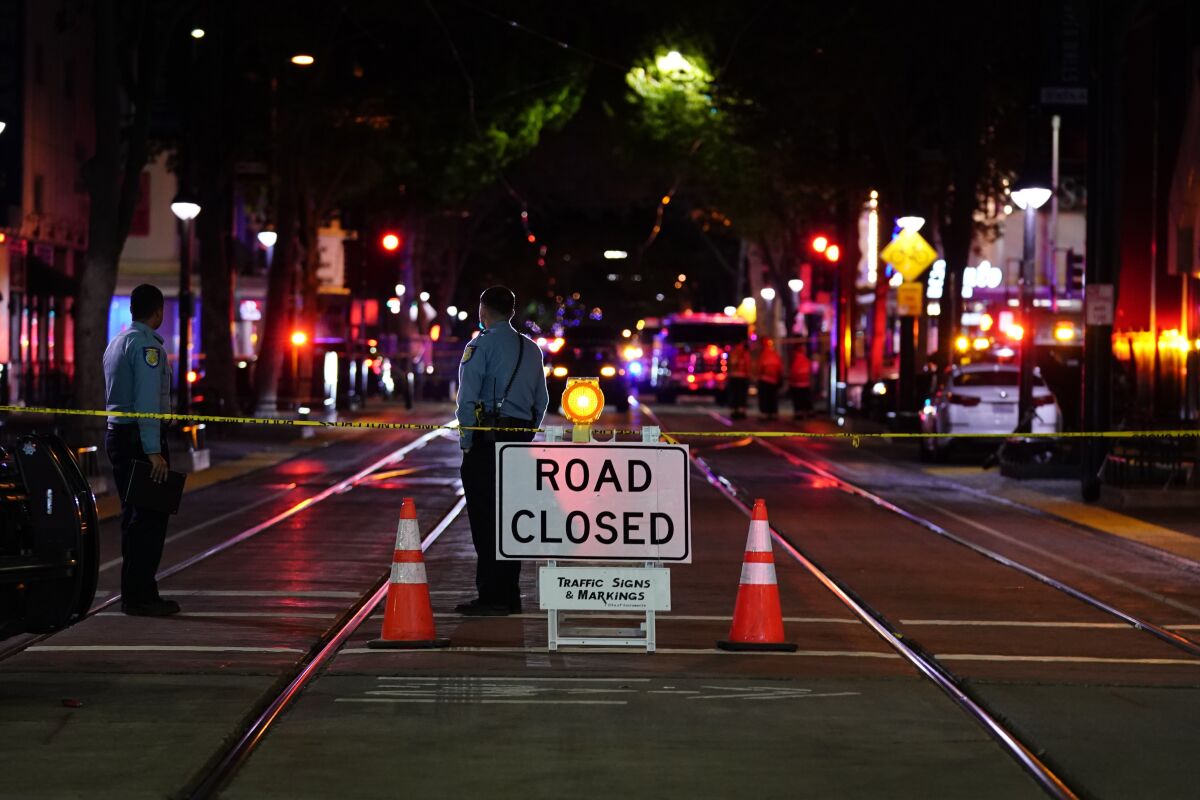 A roadblock and two officers near the scene of a shooting in downtown Sacramento early Sunday.