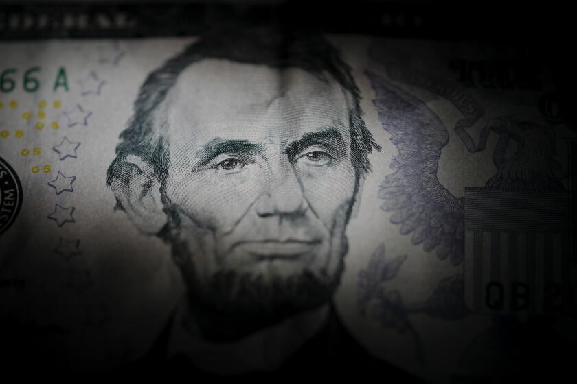 The likeness of Abraham Lincoln is seen on a U.S. $5 bill, Tuesday, March 5, 2024, in Havertown, Pa. (AP Photo/Matt Slocum)