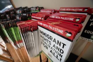 Chicago, Illinois—July 18, 2024—Volunteers assemble protest signs in preparation for a march on the Democratic National Convention, which will be held at the United Center in August. The work was organized by the Chicago Alliance Against Racist and Political Oppression and brought together volunteers from different organizations. (Alex Garcia / For the Times)