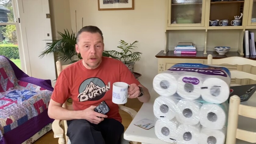 Simon Pegg next to packs of toilet paper in his coronavirus PSA.