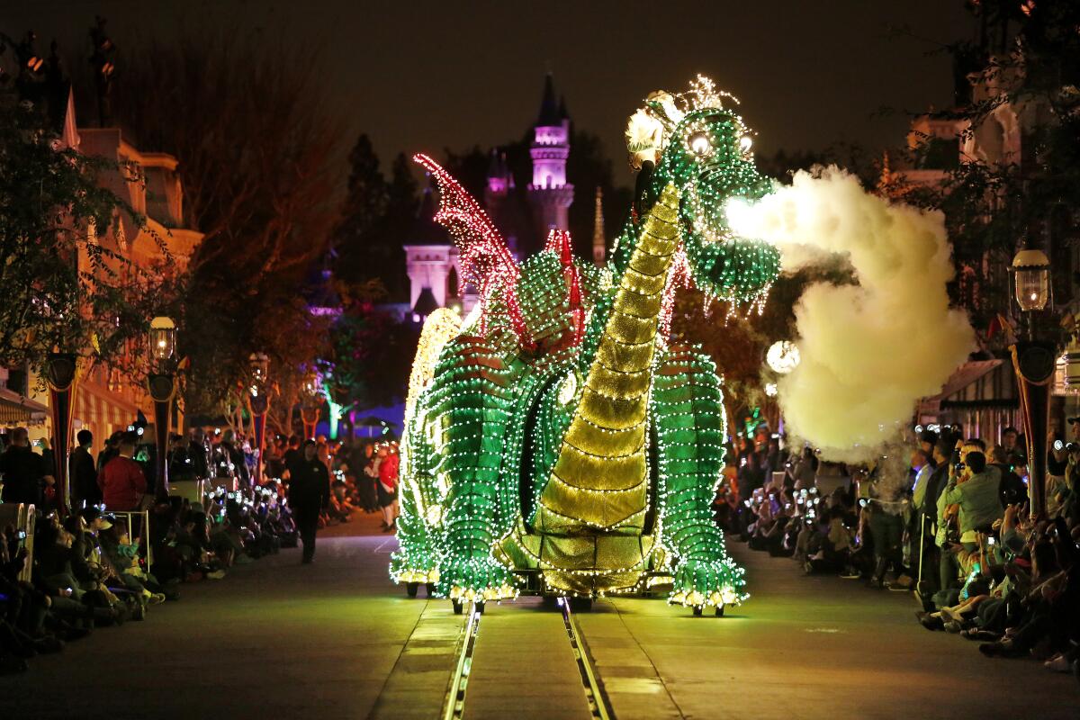 A lit-up dragon at a Disneyland parade.