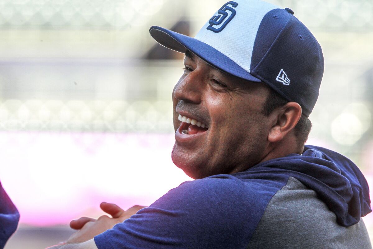 Padres interim manager Rod Barajas shares a laugh with other coaches during batting practice on Tuesday at Petco Park.