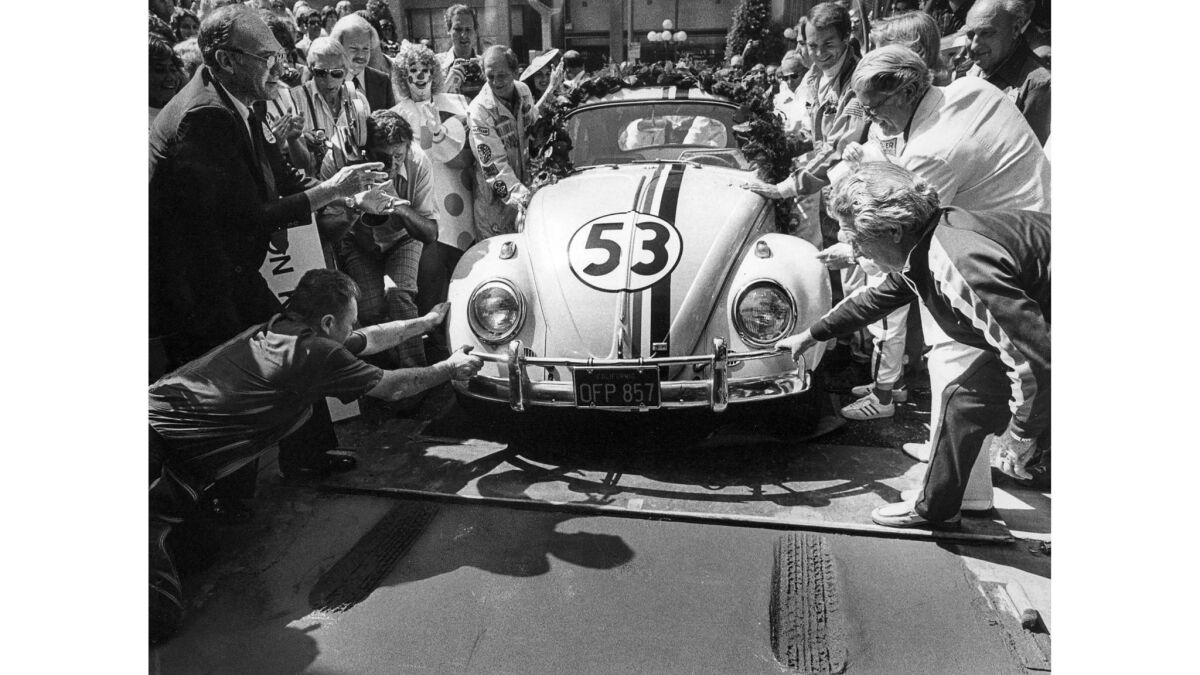 July 11, 1977: Herbie the love bug leaves tire prints in the wet concrete at Mann's Chinese Theater in Hollywood for the opening of "Herbie Goes to Monte Carlo."