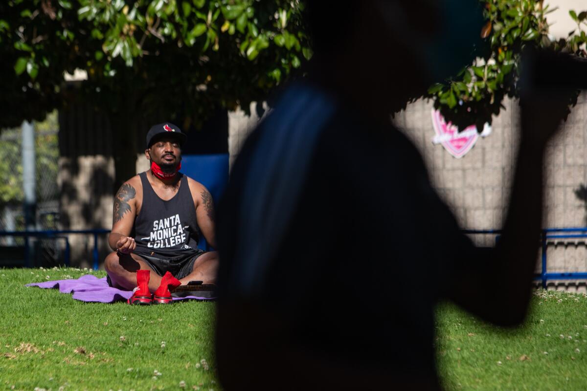 Anthony Cherro of Los Angeles relaxes in La Cienega Park in Los Angeles