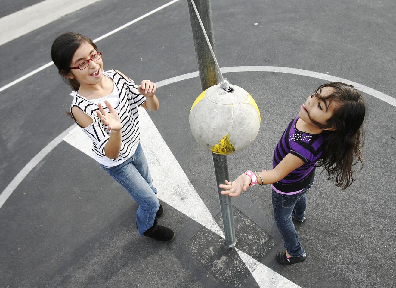 Jessica Rosales, 9, and Raechel Michel, 8, play tetherball together at McKinley Elementary School in Burbank during the After School Daze city run after-school program on Tuesday, December 4, 2012. The $60,000 program could be cut or restructured next fiscal year.