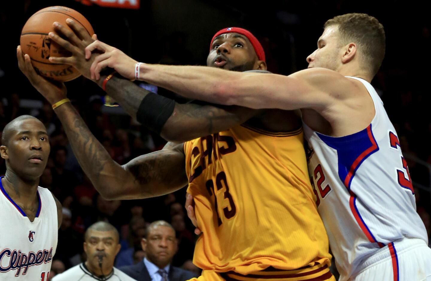 Cavaliers forward LeBron James is fouled on a drive to the basket by Clippers forward Blake Griffin in the fourth quarter Friday night at Staples Center.
