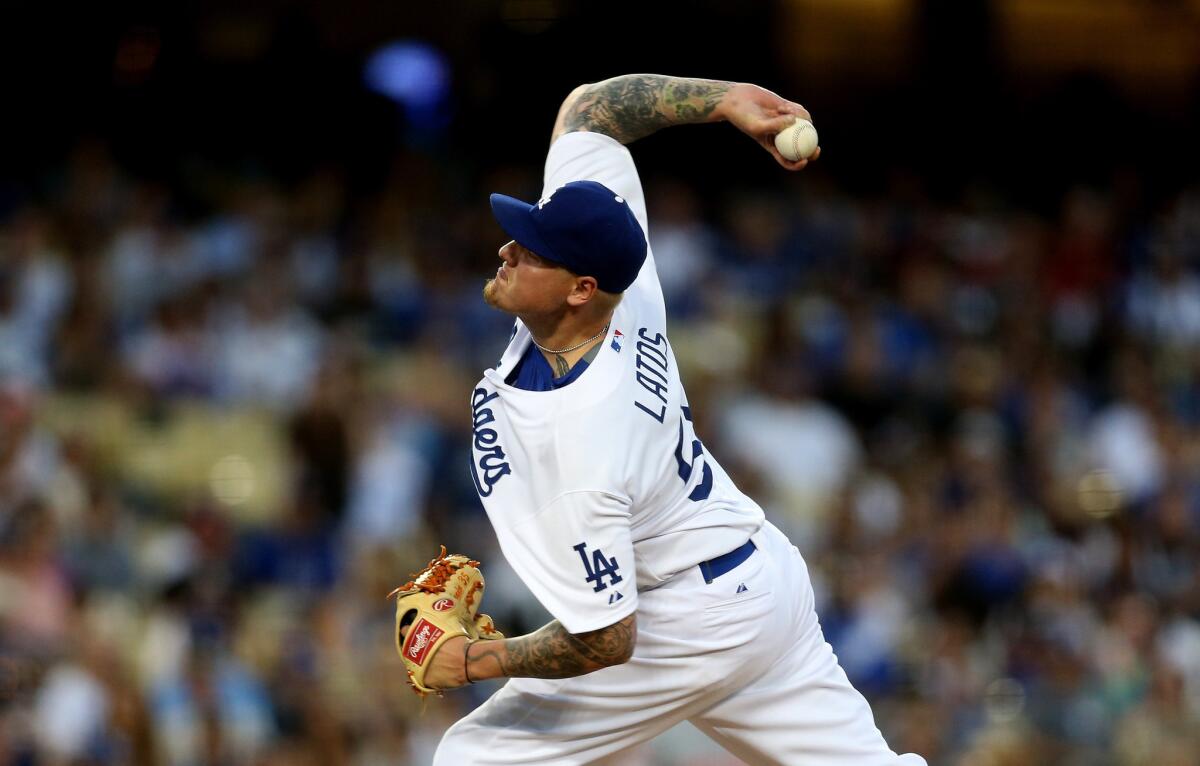 Dodgers starting pitcher Mat Latos delivers a pitch against the Reds in his last start.