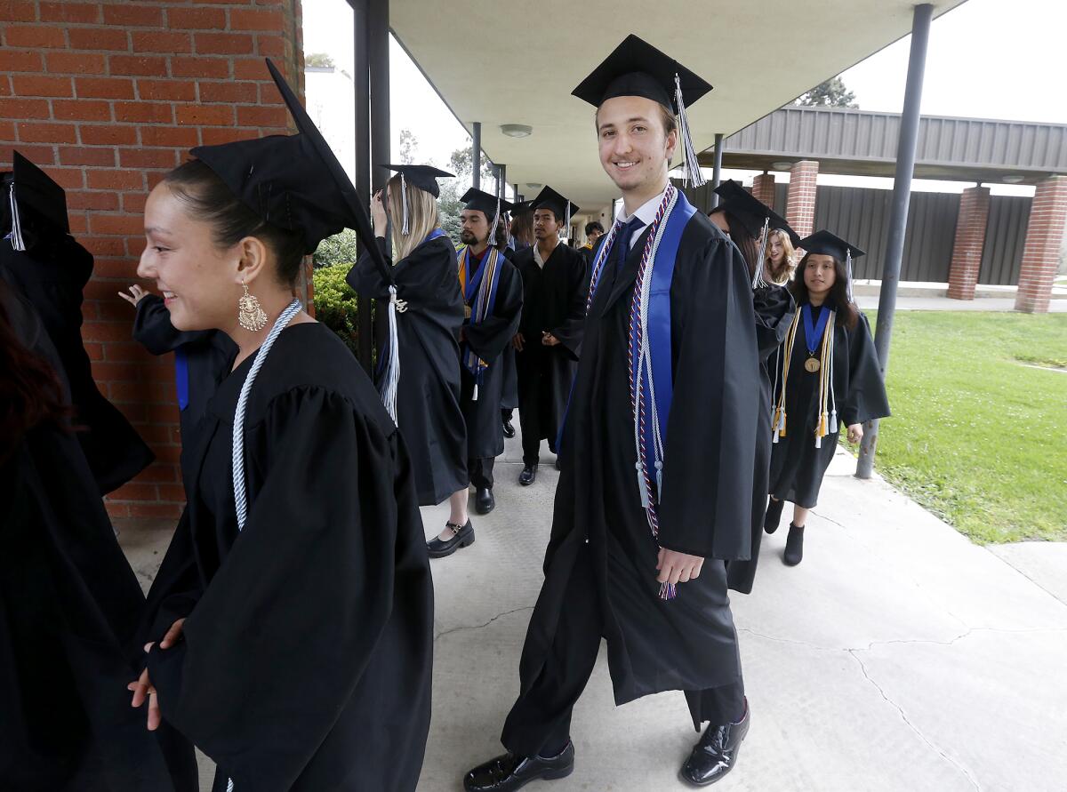 Adam Secrest grins as he participates in his graduation ceremony Thursday.