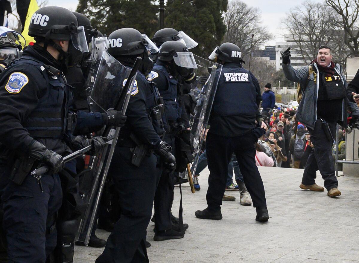 A man yelling at a line of police 