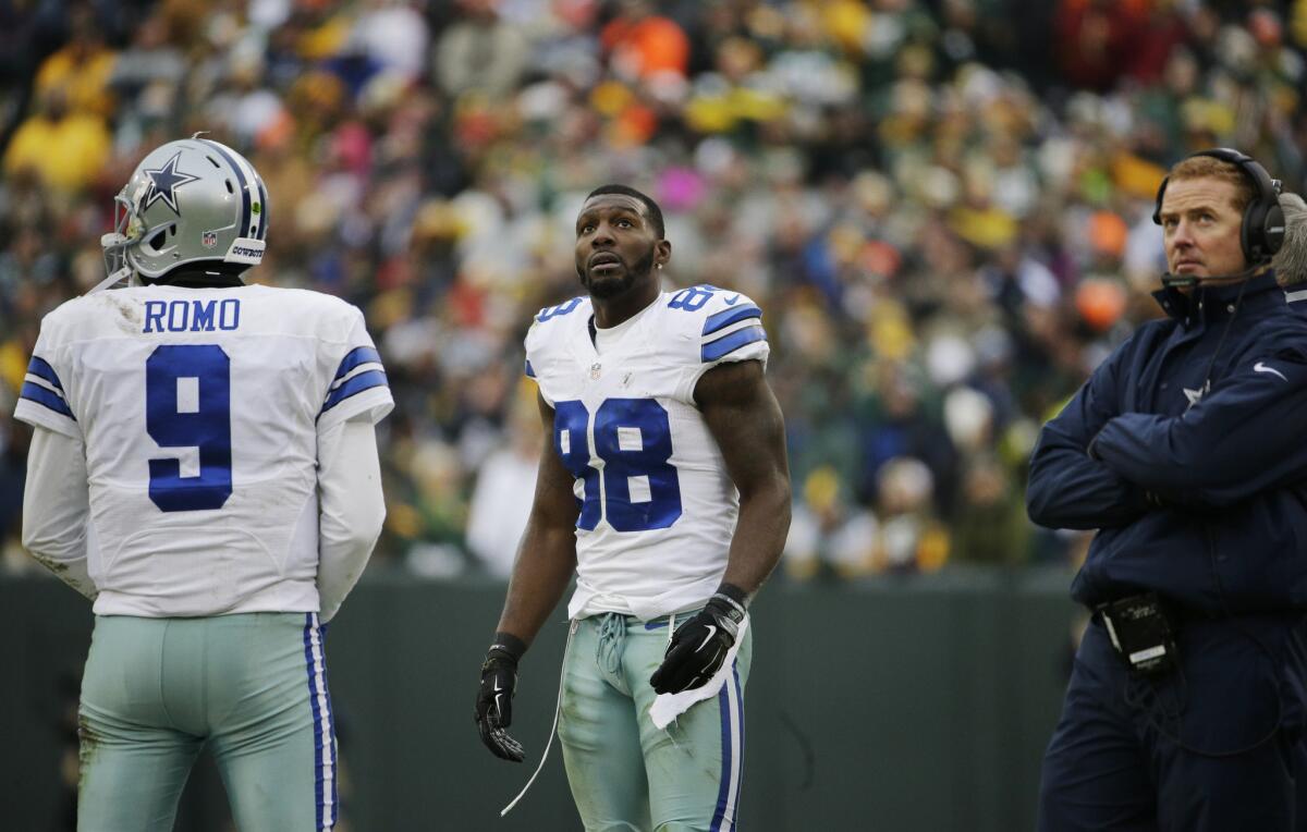 Dallas Cowboys reciever Dez Bryant watches the scoreboard as officials review a catch during the second half of an NFC divisional playoff game.