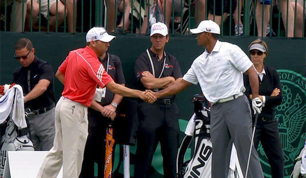 Sergio Garcia and Tiger Woods shake hands on the driving range during practice for the U.S. Open at Merion Golf Club in Ardmore, Pa. on Tuesday.