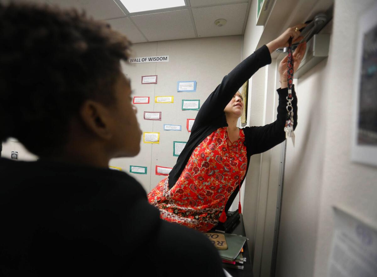 A teacher secures a classroom door during an active shooter drill.
