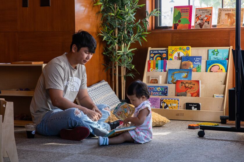 San Diego, CA - August 05: Joon Son plays with his 16-month year old daughter Maddi at The New Haven open house in Liberty Station in San Diego, CA on Friday, Aug. 5, 2022. The small business operates a co-working and childcare space in one site. (Adriana Heldiz / The San Diego Union-Tribune)